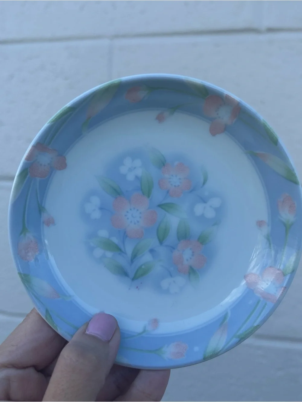 Vintage small butter pat dish featuring a light blue rim delicate floral patter